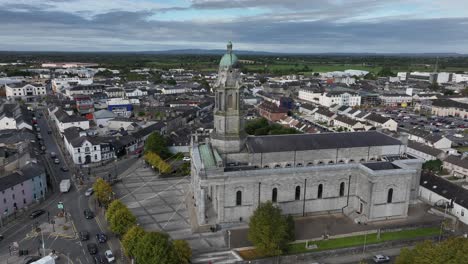 st mel's cathedral, longford town, county longford, ireland, september 2024. drone orbits clockwise descending slowly towards the front of the restored catholic church with communiting pedestrians.
