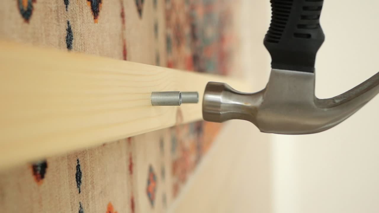 Hammering a Nail into Wood