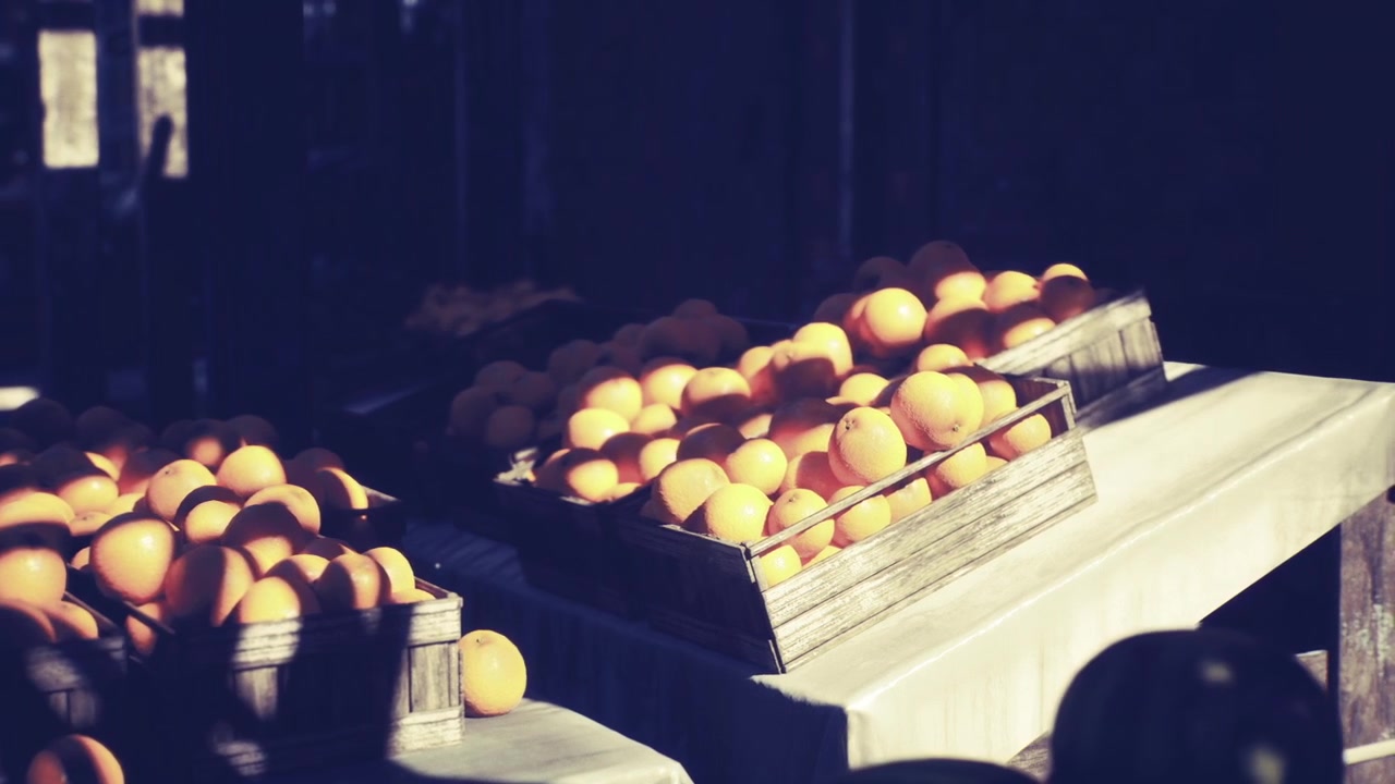 Sunkissed market stall exhibits array of luscious oranges in warm morning glow