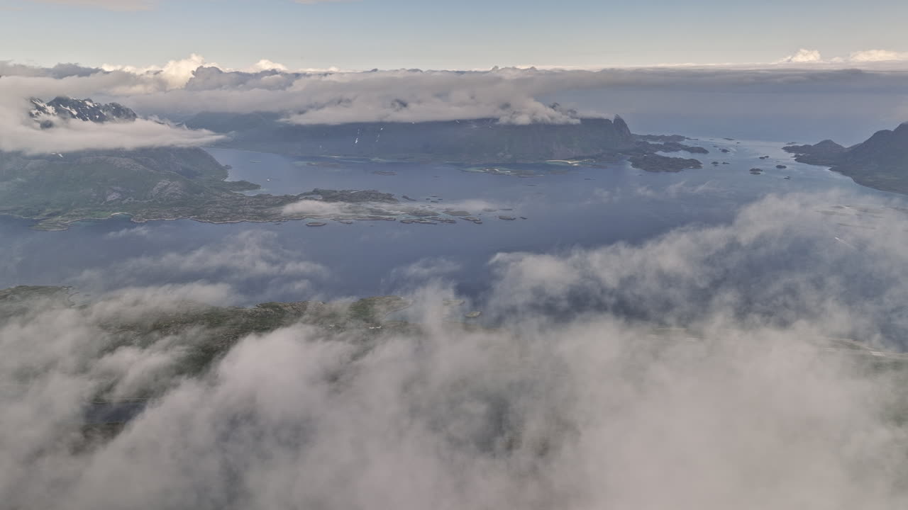 djevelporten norway aerial v4 panoramic high altitude panning view capturing beautiful lofoten landscape covered in thick layer of fluffy white clouds in the sky - shot with mavic 3 cine - june 2022