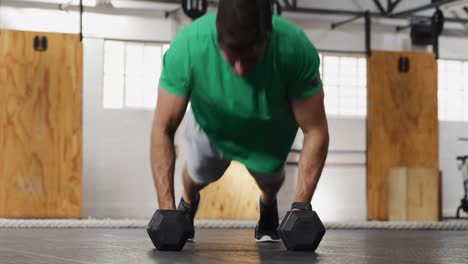 Front-view-athletic-Caucasian-man-lifting-alternate-weights