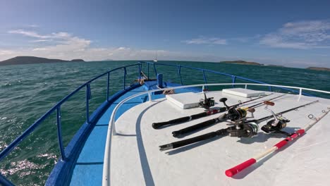 a serene boat ride with fishing gear on a sunny day in phuket, capturing the ocean's beauty and tranquility