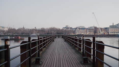 beautiful wide angle establishing shot pier on river thames in london