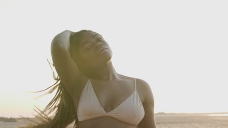 beautiful black model posing at the beach with a bikini set