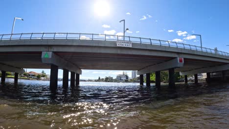 bridge crossing canal with cityscape in background