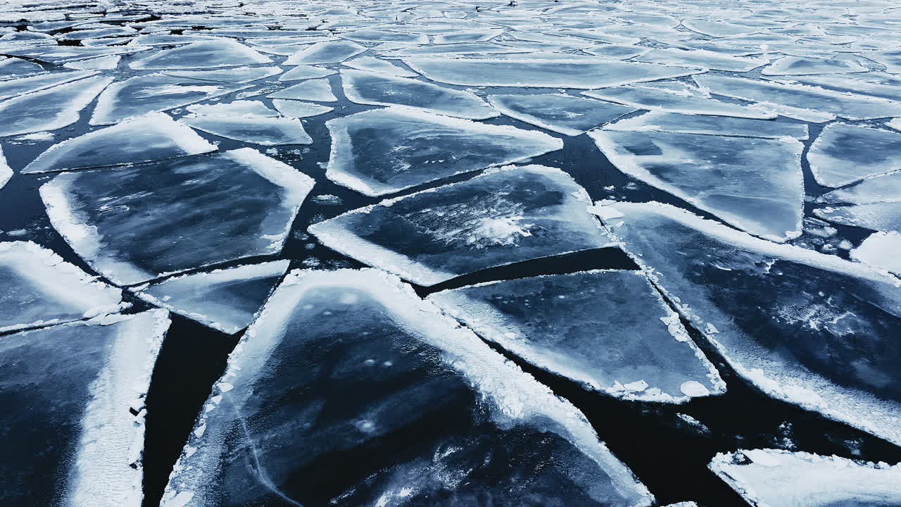 Drohnenaufnahme schwenkt herum und zeigt riesige Eisschollen im Michigansee.