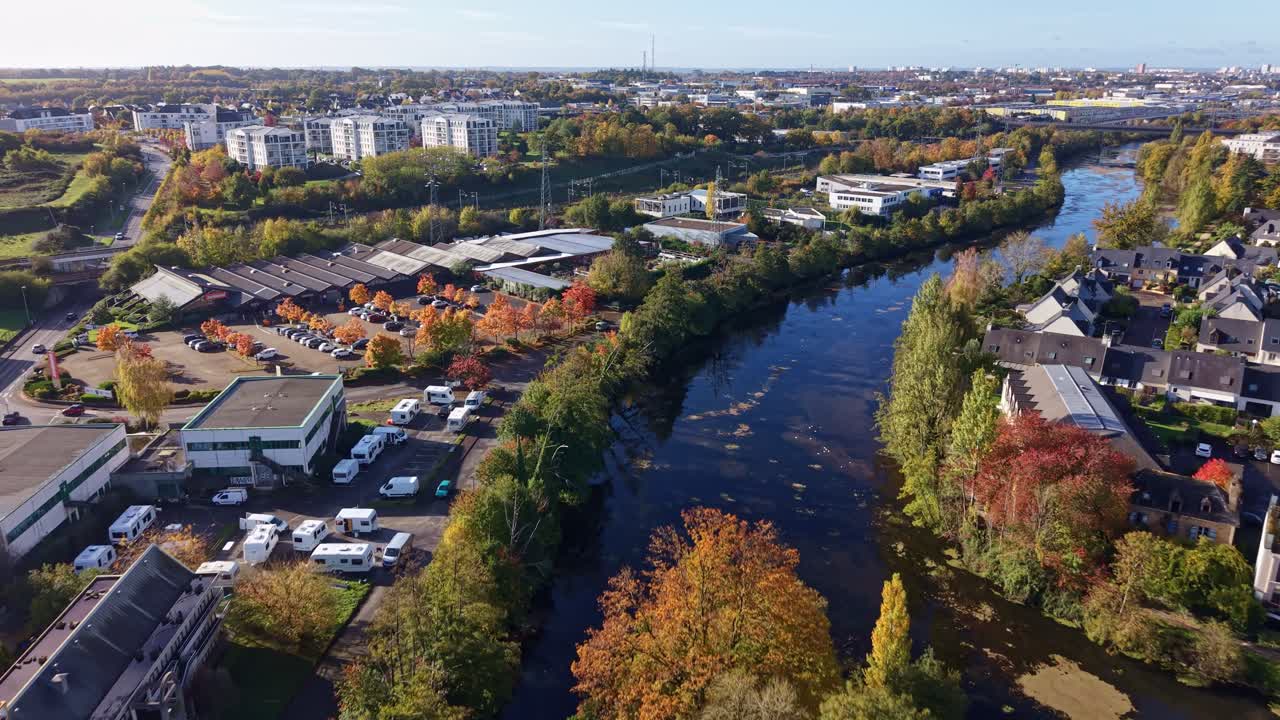 Forward drone fly over the Vilaine River with Cesson-Sévigné road connection in autumn, Ille-et-Vilaine, France