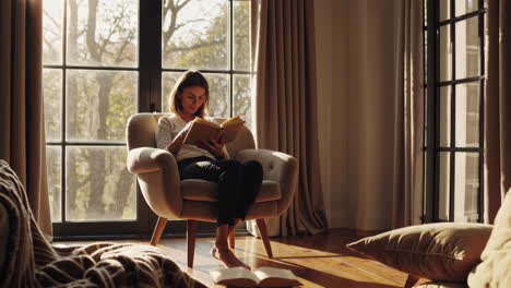 woman reading a book in a cozy living room