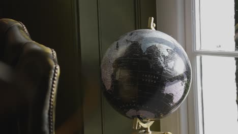 earth globe next to window