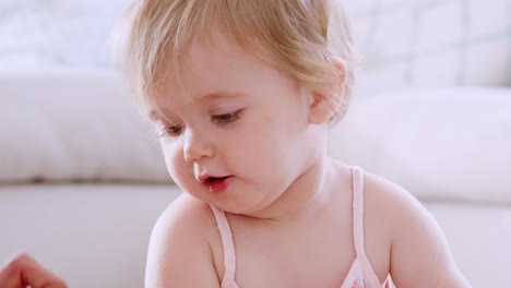 happy toddler girl playing with toys at home, close up