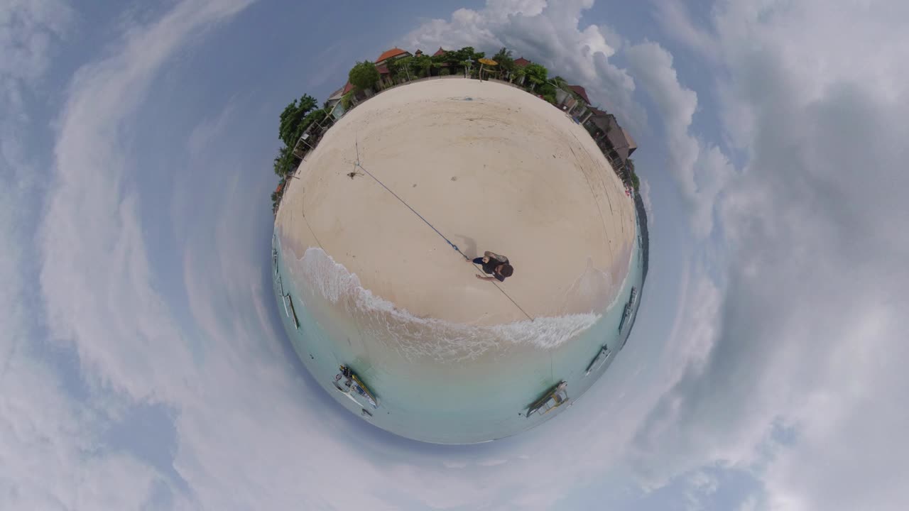 Little Tiny Planet 360 Degree Footage of lonely man walking on paradise shore of Indonesian island.