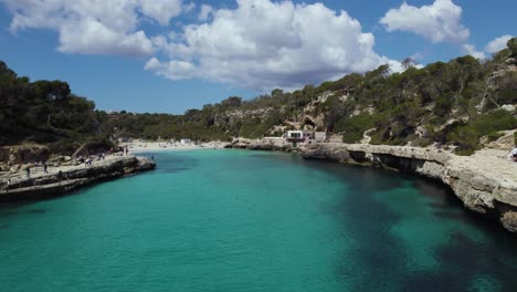 tourists at cala llombards on sunny summer day in mallorca, balearic islands, spain