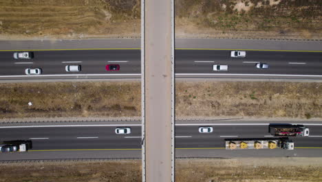 farm bridge over highway crossroads in summer, aerial top down drone view