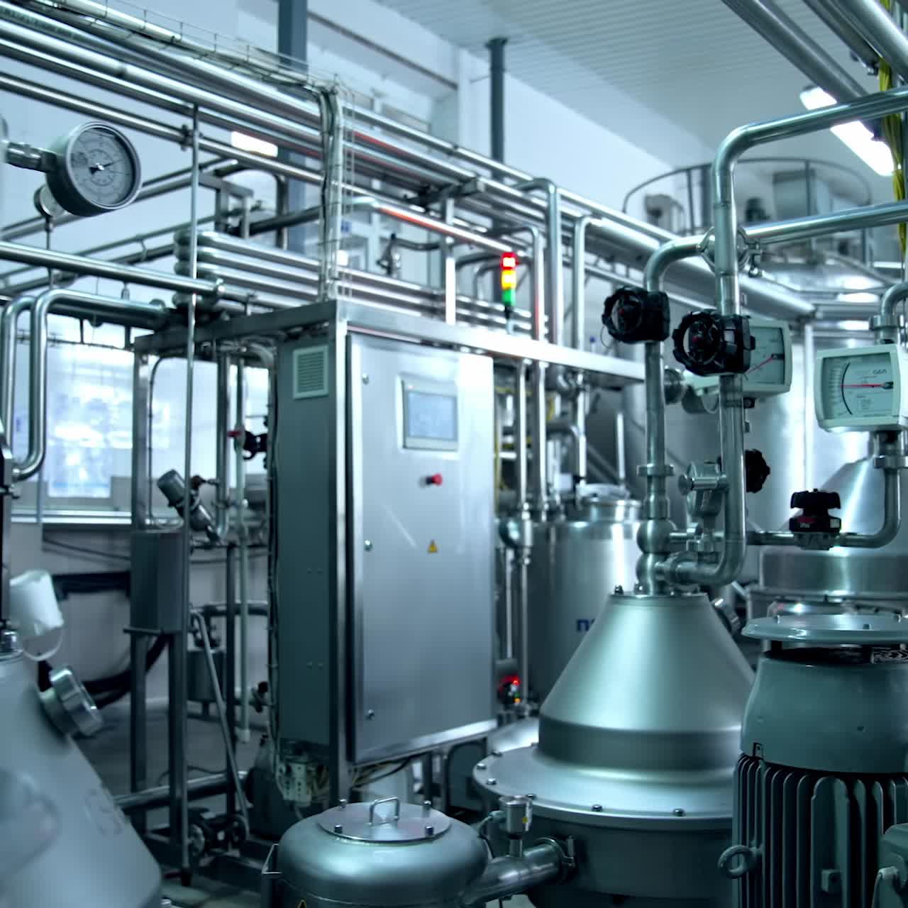 ?omplex pipe system with sensors at milk production factory. Ramified pipeline system for dairy manufacturing company. Big light premise with tanks and pipes for milk factory