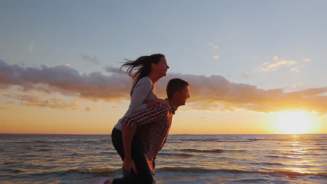 Loving-Couple-Having-Fun-On-The-Beach-Berugu-Girl-Riding-On-Guy-Shows-His-Hand-Forward-Prores-Hq-10