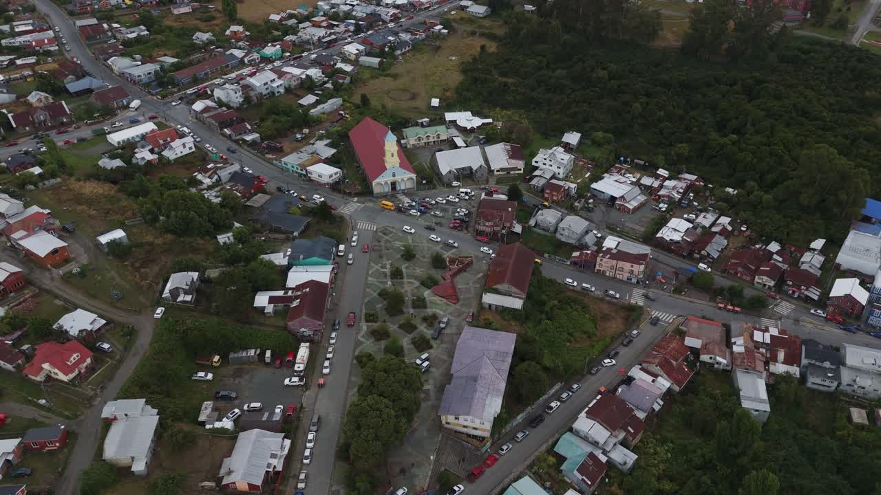 Aerial view of Chonchi, a charming town in the Los Lagos Region of Chile, showcasing its unique architecture and serene atmosphere. orbit motion