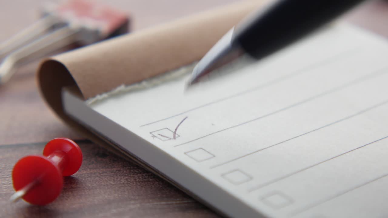 Checking off tasks on a small notepad