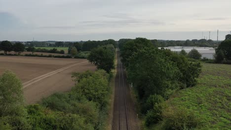 a drone flies in good weather at a very low altitude over railway tracks