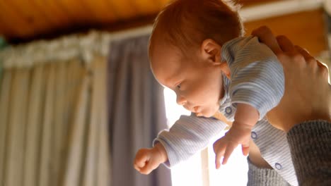 Mother-holding-her-baby-boy-at-home-4k