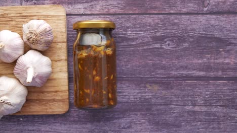 homemade garlic pickle in a glass jar on table ,