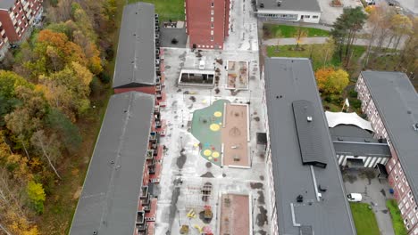 Aerial-View-Of-Apartment-Blocks-With-Autumn-Foliage-In-The-Surroundings