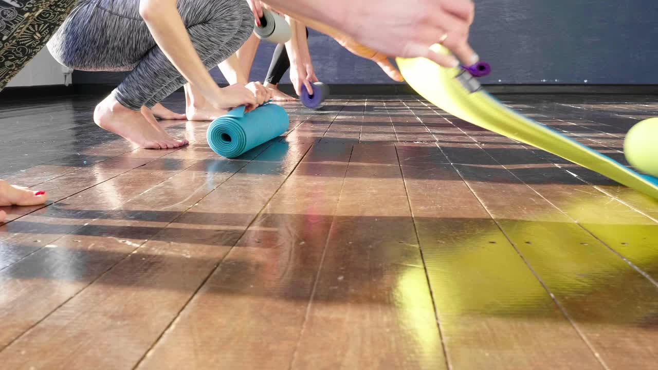 Women in yoga class, preparing for a session