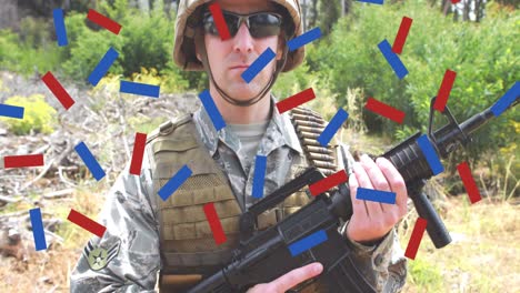 composición de confeti rojo y azul, sobre soldado masculino en el bosque sosteniendo una pistola
