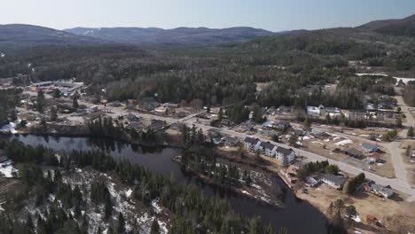 aerial-high-angle-of-Saint-Côme-surrounded-by-woodland-tree-forest-and-river-in-Quebec