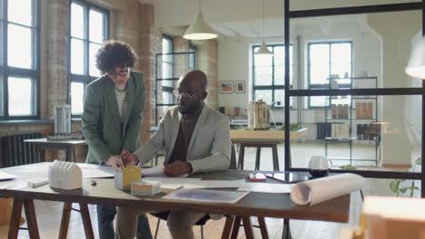 architects collaborating on plans in a modern office