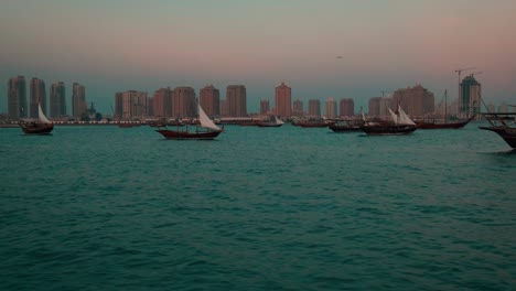 dhows with qatar flag in arabic gulf sunset shot