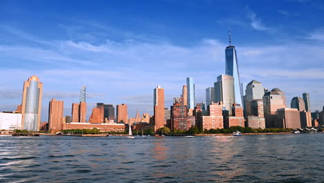 modern skyline of new york on sunny day. footage from the waterscape of the river. tourism in america