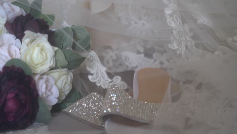 gorgeous bridal detail layout with the vale covering overtop and the dress as the background