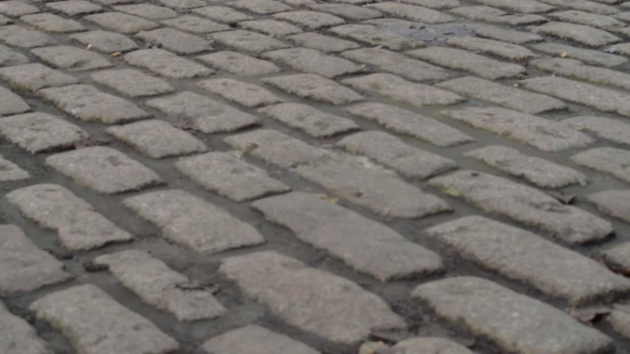 Old cobbled street with grey paving in urban town