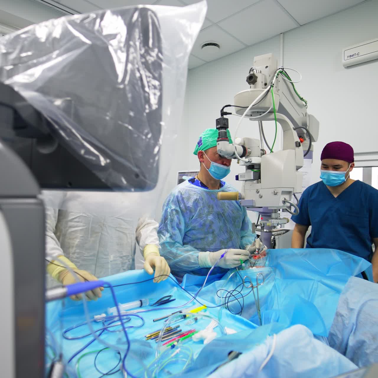 Modern surgery room with innovative equipment for ophthalmic operations. Eyesight operation performed by the team of medics