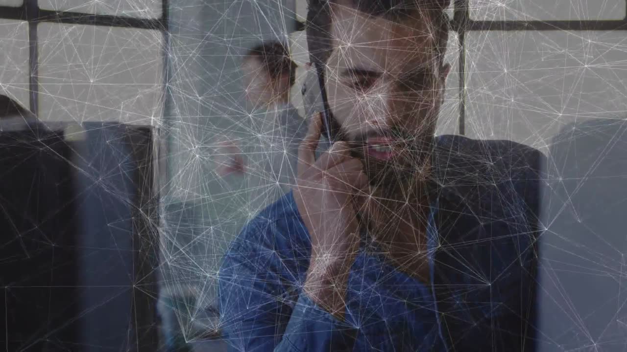 Man raising phone, conducting business call for update, web overlay tracing link to monitor