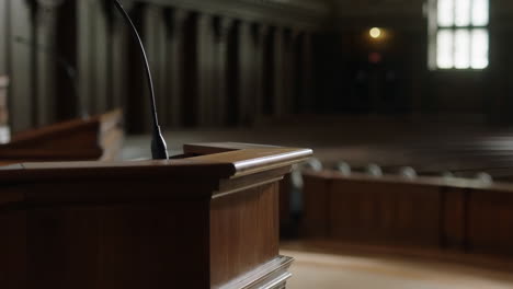 empty courtroom or formal hall with a podium and microphone