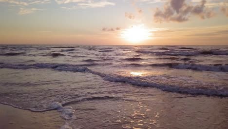 beautiful aerial establishing view of baltic sea coast on a sunny evening, sunset, golden hour, beach with white sand, coastal erosion, climate changes, low wide angle drone shot moving forward