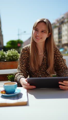 woman using tablet in a cafe