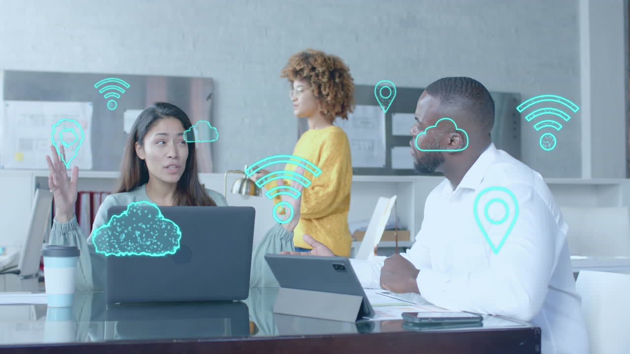 Digital communication icons over diverse female and male colleague at casual office meeting
