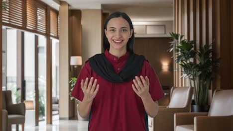 happy indian female hotel staff talking to guests