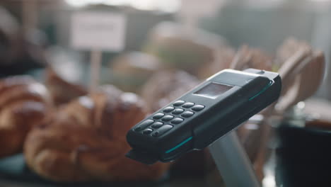 close up customer paying using credit card contactless payment in cafe spending money with wireless transaction in restaurant coffee shop