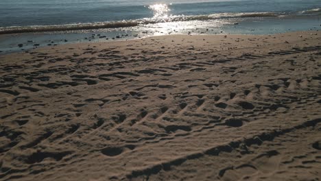 drone moving forward at the beach tilting up to reveal vast calm ocean