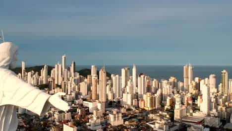 Revelaing-shot-ot-Christ-the-redeemer-in-Brazil-with-city-in-background