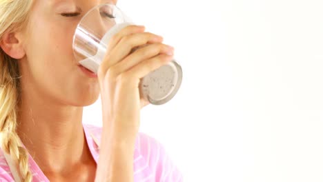 woman drinking grape smoothie against white background