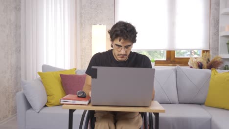 Disabled-young-man-working-hard-with-laptop.