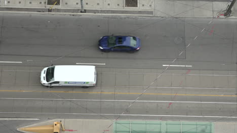 Topdown-view-of-the-street-as-cars-drive-past-in-slow-motion