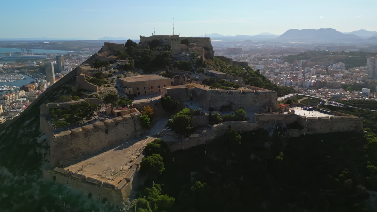 Aerial drone view of the Santa Barbara Castle on the coast of Alicante, Spain with the city and the sea on the background