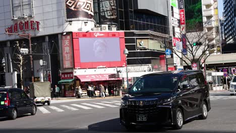 pedestrians and vehicles crossing a city intersection