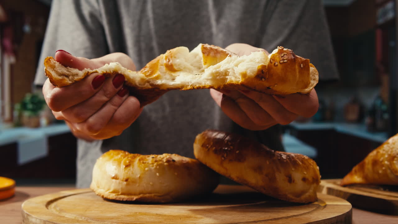Woman holding pieces of freshly baked bread
