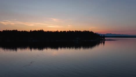 herron island at sunset with clear and calm water surrounding it